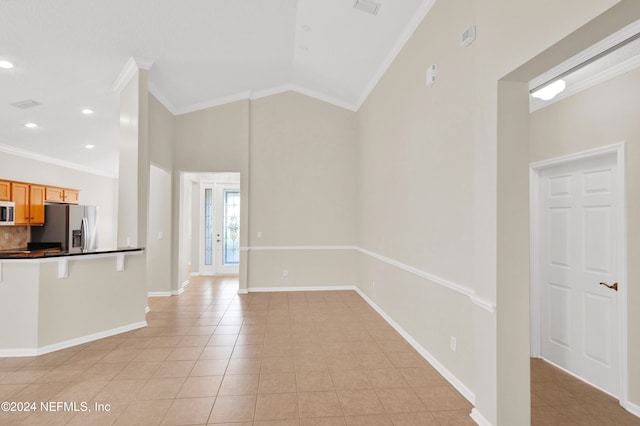 kitchen with light tile patterned flooring, high vaulted ceiling, ornamental molding, and appliances with stainless steel finishes