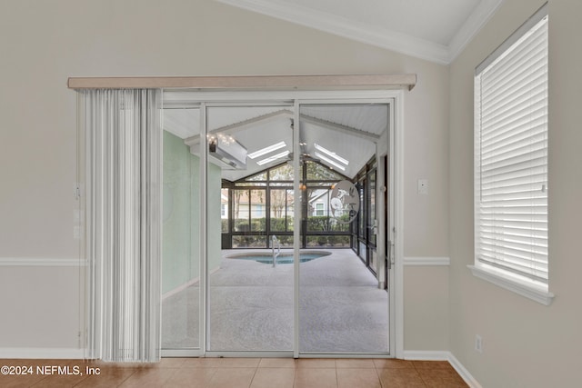 doorway with light tile patterned floors and vaulted ceiling