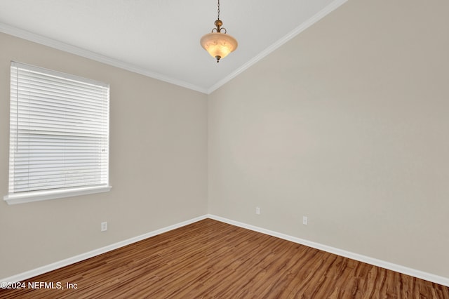 unfurnished room featuring wood-type flooring and ornamental molding