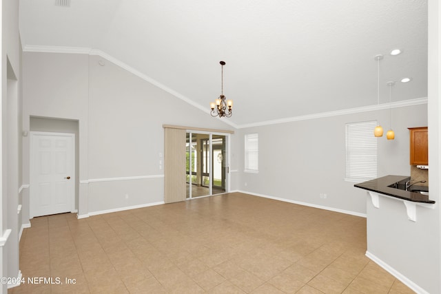 unfurnished living room with crown molding, high vaulted ceiling, and an inviting chandelier