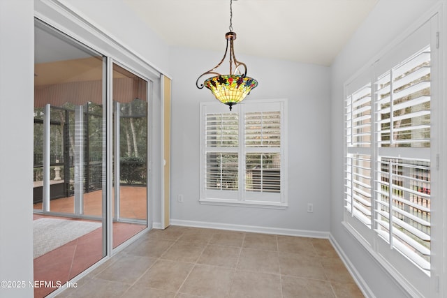 interior space featuring vaulted ceiling and light tile patterned floors