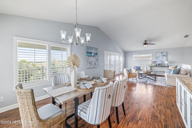 dining area with dark wood-type flooring, lofted ceiling, plenty of natural light, and ceiling fan with notable chandelier