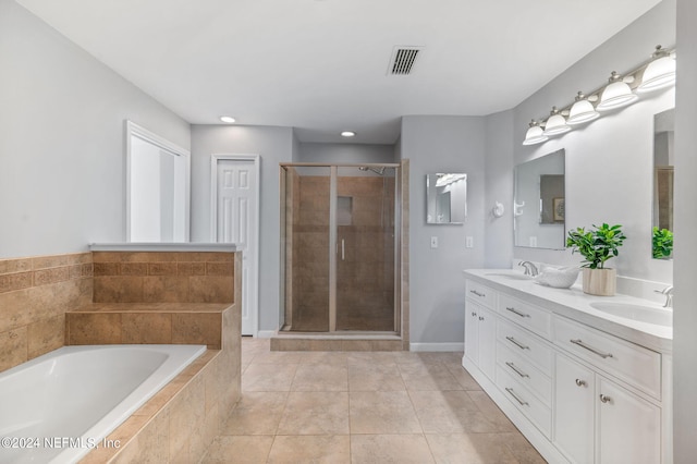 bathroom featuring vanity, tile patterned floors, and plus walk in shower