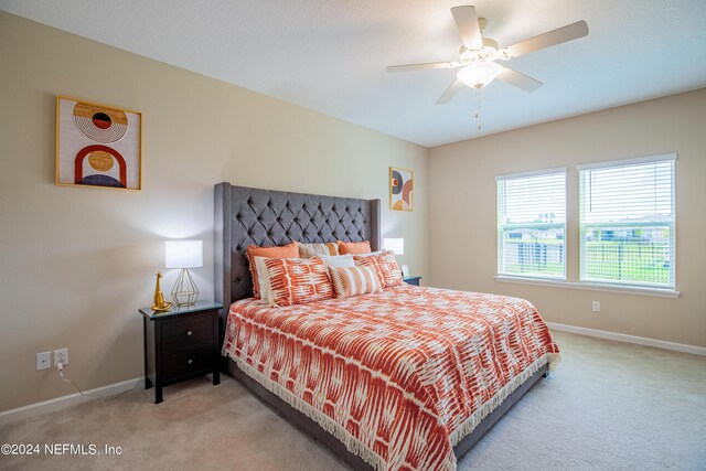 carpeted bedroom with ceiling fan