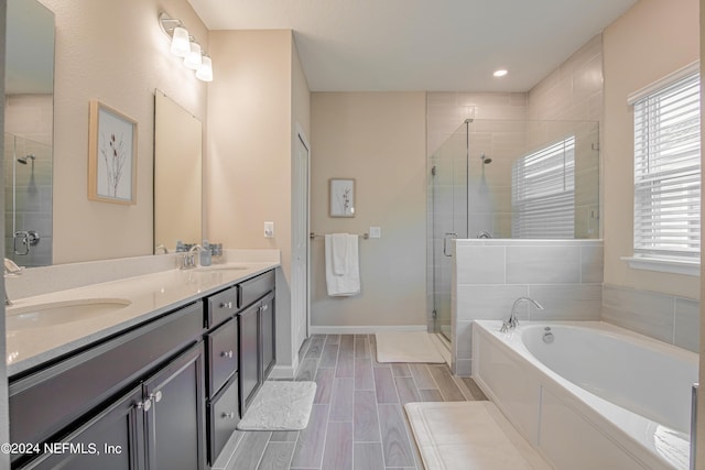 bathroom featuring plus walk in shower and vanity