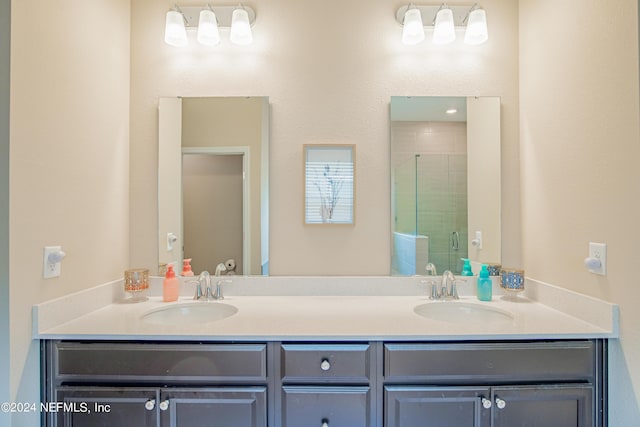 bathroom featuring vanity and a shower with shower door