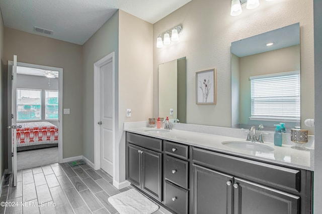 bathroom with hardwood / wood-style floors, vanity, and ceiling fan