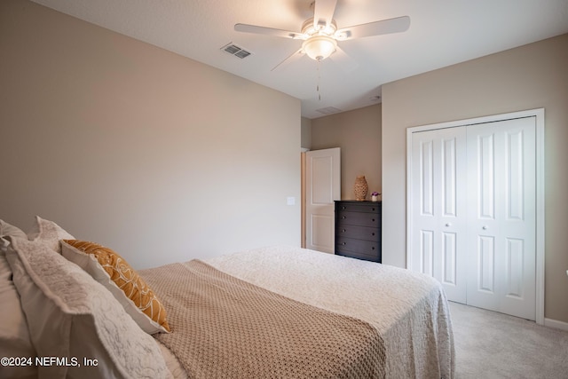 carpeted bedroom featuring ceiling fan and a closet