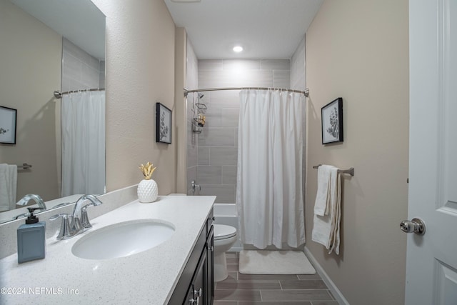 full bathroom featuring vanity, shower / bath combination with curtain, and toilet