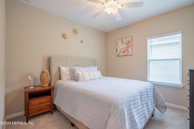 bedroom with ceiling fan and light carpet