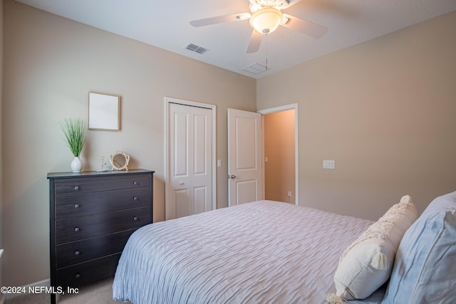 carpeted bedroom with a closet and ceiling fan