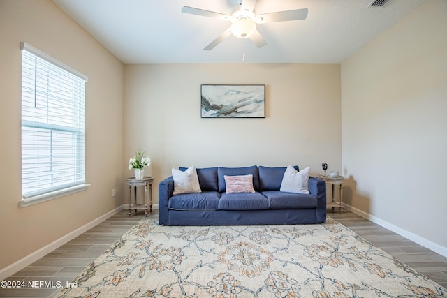 living room with ceiling fan, plenty of natural light, and hardwood / wood-style floors