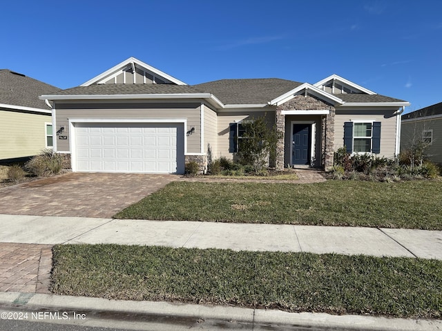 view of front of property featuring a garage and a front lawn