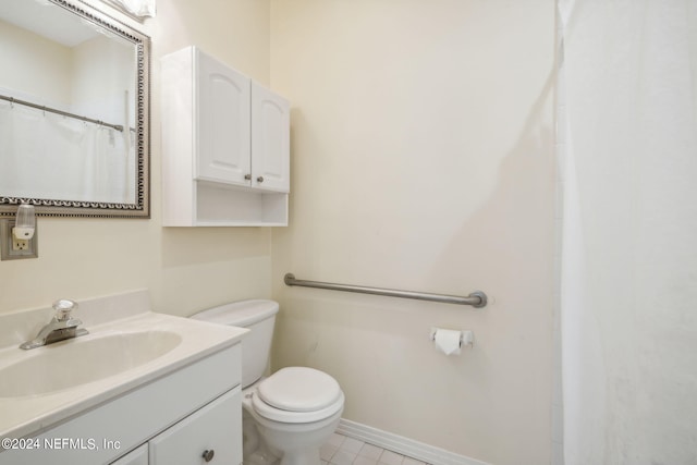 bathroom with tile patterned floors, vanity, and toilet