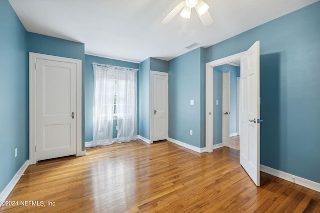 unfurnished bedroom featuring ceiling fan and light wood-type flooring