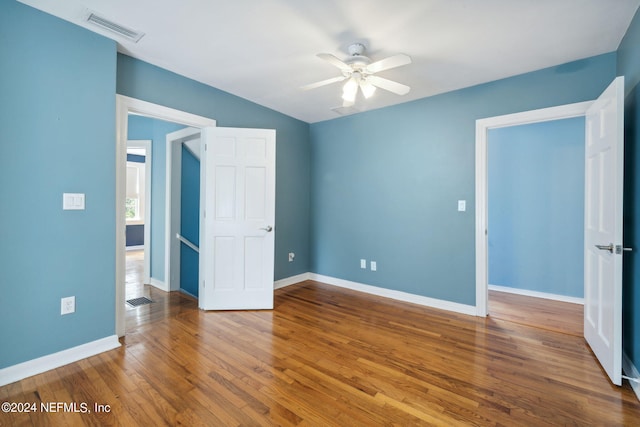 unfurnished bedroom featuring hardwood / wood-style floors and ceiling fan