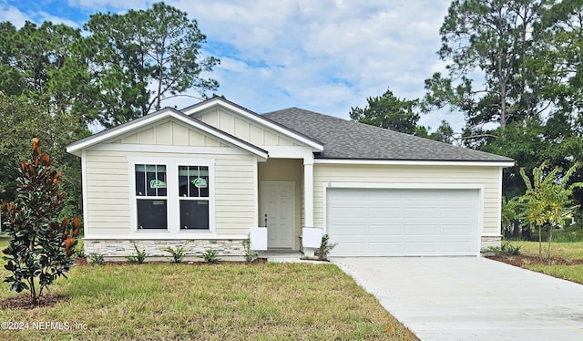 view of front of property with an attached garage, stone siding, driveway, and board and batten siding