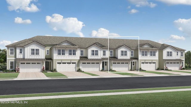 townhome / multi-family property featuring driveway, a standing seam roof, board and batten siding, metal roof, and a garage