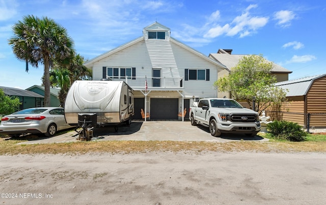 view of front facade featuring a garage and a balcony