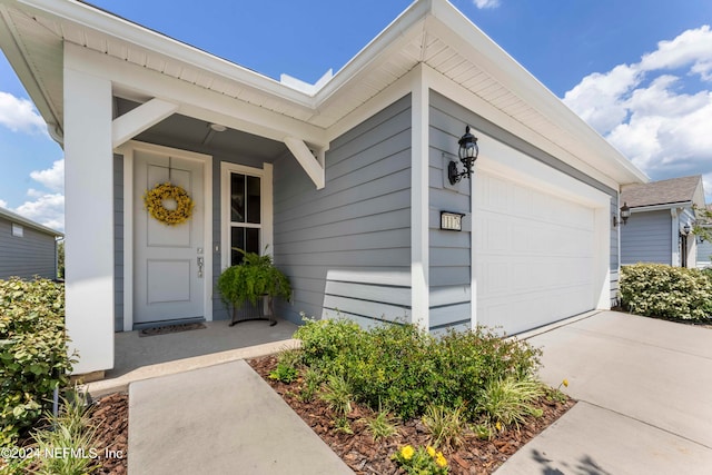 view of exterior entry with a garage