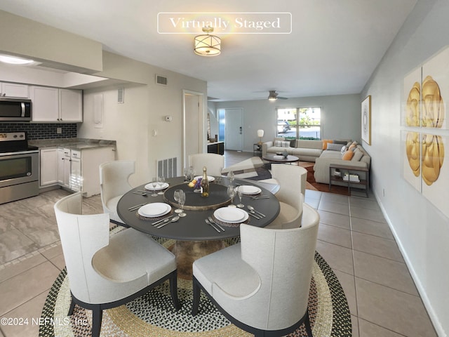 tiled dining area with ceiling fan