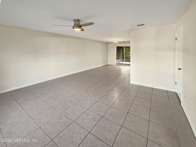 tiled empty room with ceiling fan