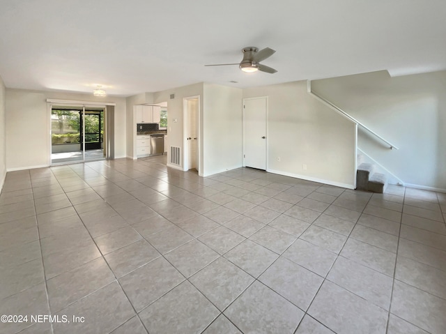 unfurnished living room featuring ceiling fan and light tile floors