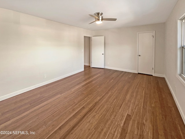 spare room featuring ceiling fan and dark wood-type flooring