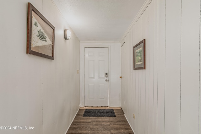 doorway to outside featuring hardwood / wood-style flooring and a textured ceiling