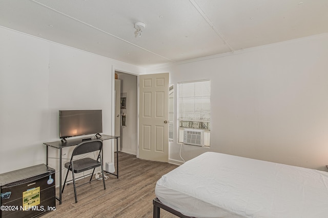 bedroom with hardwood / wood-style floors