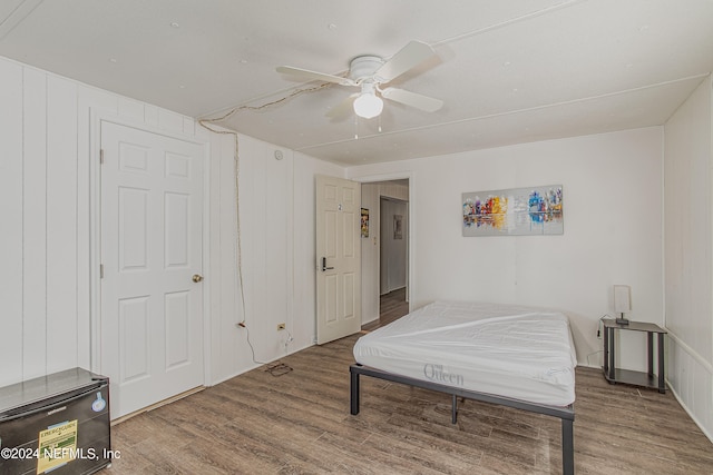 bedroom with hardwood / wood-style floors and ceiling fan