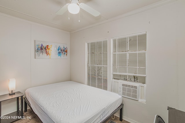 bedroom with wood-type flooring, ceiling fan, and crown molding