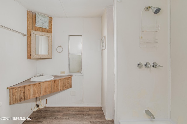 bathroom featuring shower / bath combination, hardwood / wood-style flooring, and vanity