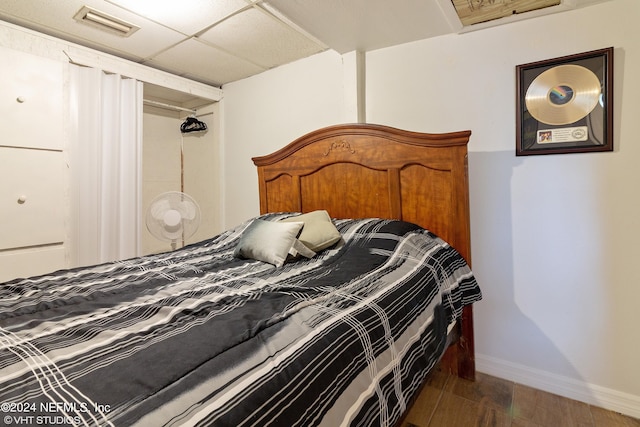 bedroom with hardwood / wood-style flooring and a drop ceiling