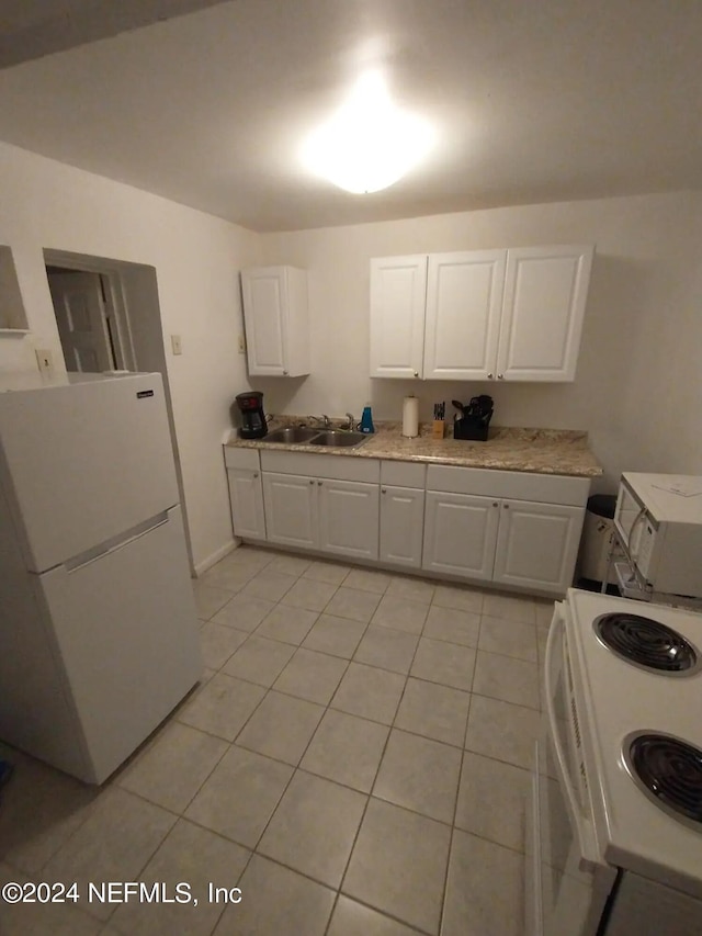 kitchen with sink, range, white cabinets, and white fridge