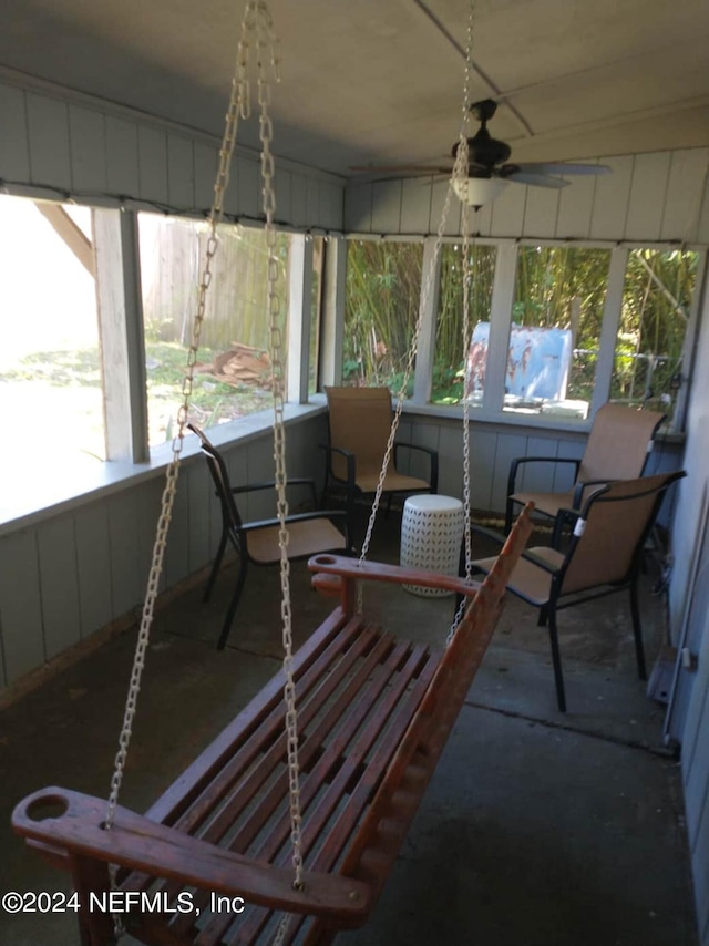 sunroom with a healthy amount of sunlight and ceiling fan