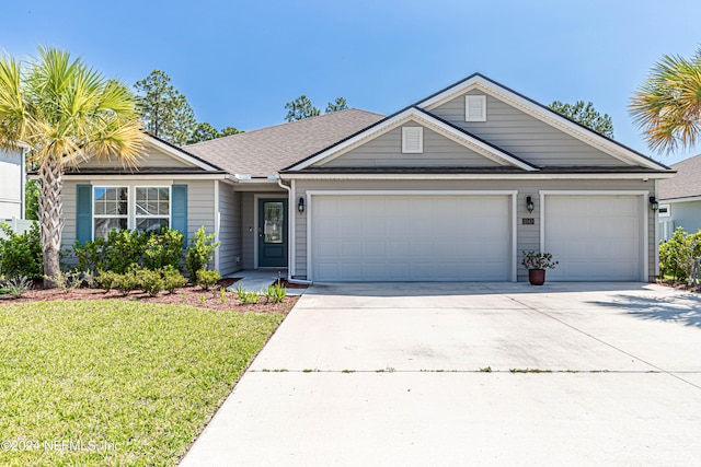 view of front of house with a front yard and a garage