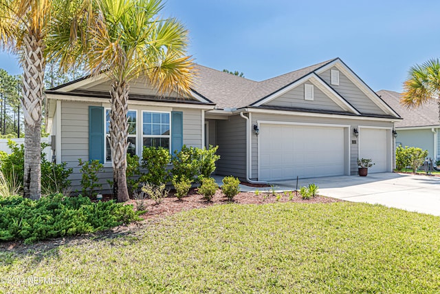 view of front of home with a garage and a front lawn