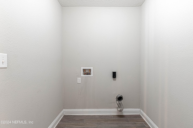 washroom featuring hookup for an electric dryer, hookup for a washing machine, dark hardwood / wood-style floors, and a textured ceiling