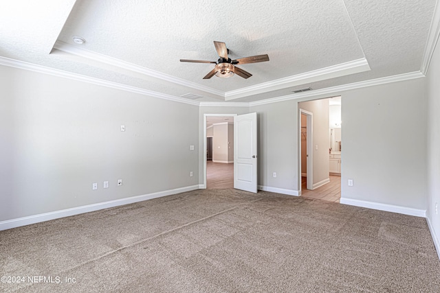 unfurnished bedroom featuring ceiling fan, carpet flooring, and a raised ceiling