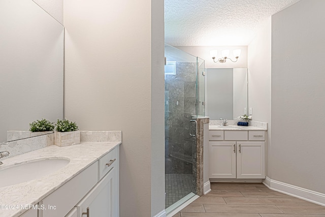 bathroom featuring walk in shower, a textured ceiling, and vanity