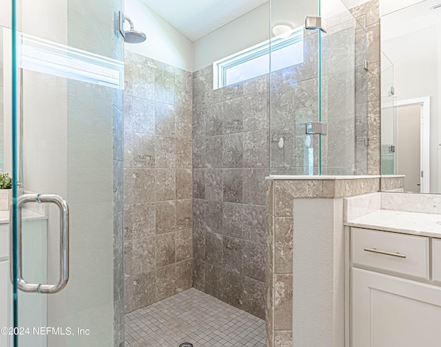 bathroom featuring an enclosed shower and vanity