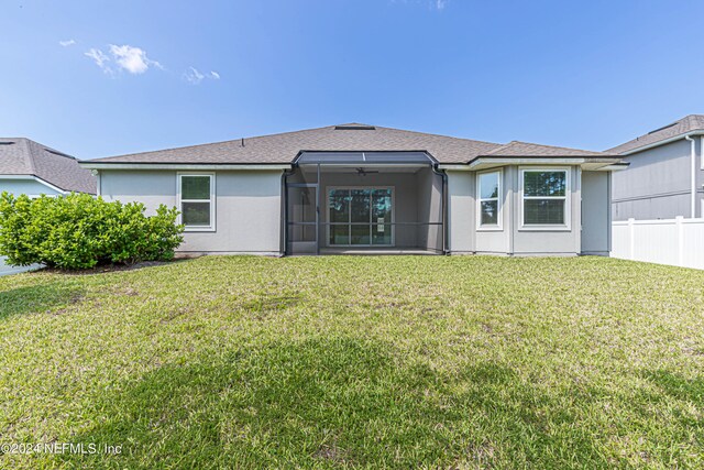 back of house featuring a yard