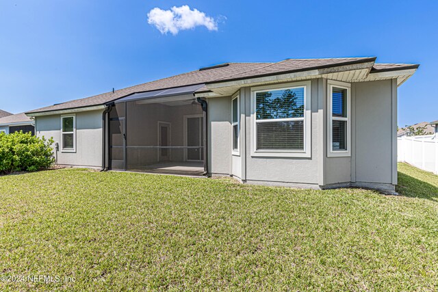 back of house with a yard