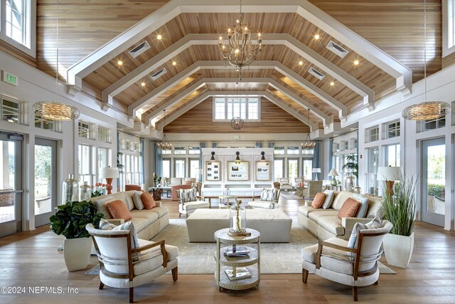 living room with high vaulted ceiling, a wealth of natural light, a chandelier, and wooden ceiling