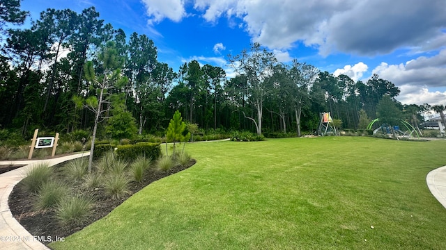 surrounding community featuring a playground and a yard