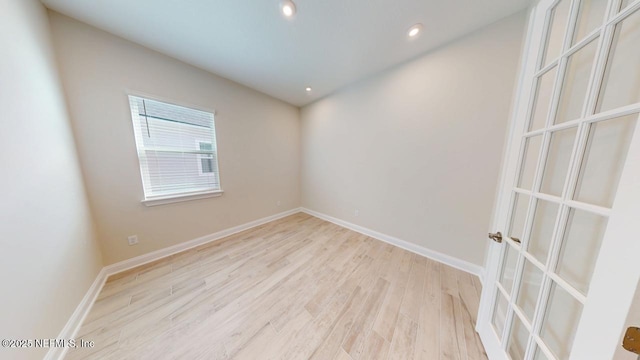 unfurnished room featuring recessed lighting, light wood-type flooring, and baseboards