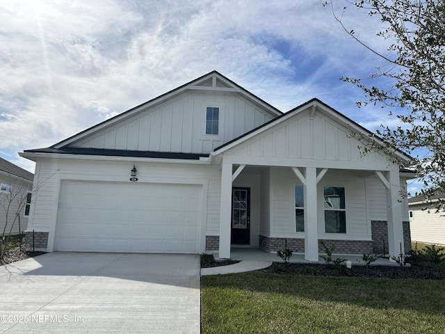 view of front of property with driveway, an attached garage, a front lawn, board and batten siding, and brick siding