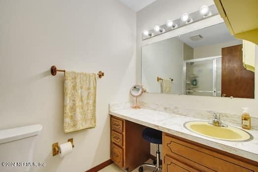 bathroom with toilet and oversized vanity