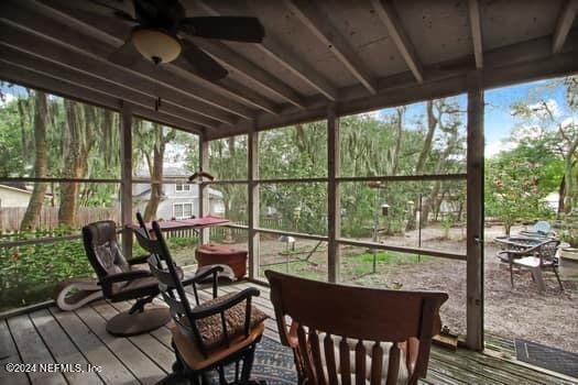 sunroom / solarium featuring ceiling fan